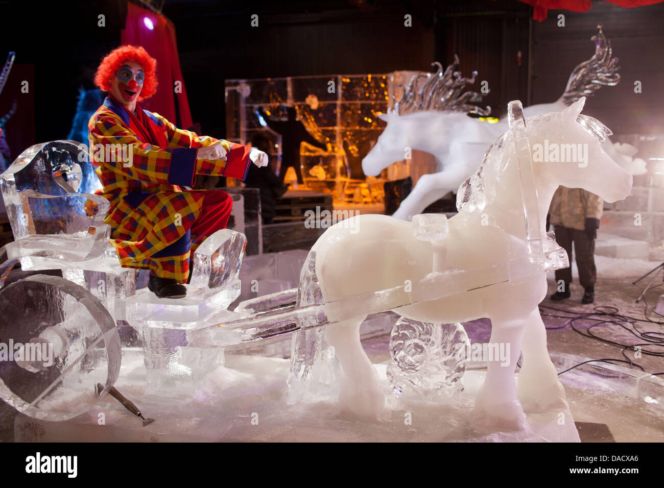 A cclown sits in a carriage made of ice at the adventure village in ...