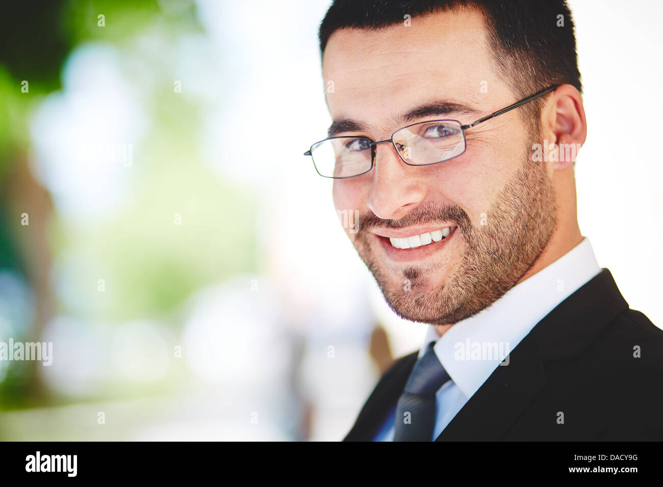 Close-up portrait of a successful business guy smiling ambitiously Stock Photo