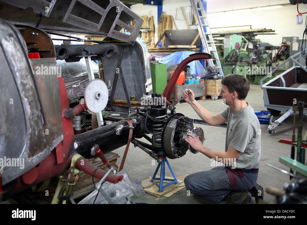 Automobile mechanic Peter Spillner works on the car body of a Mercedes