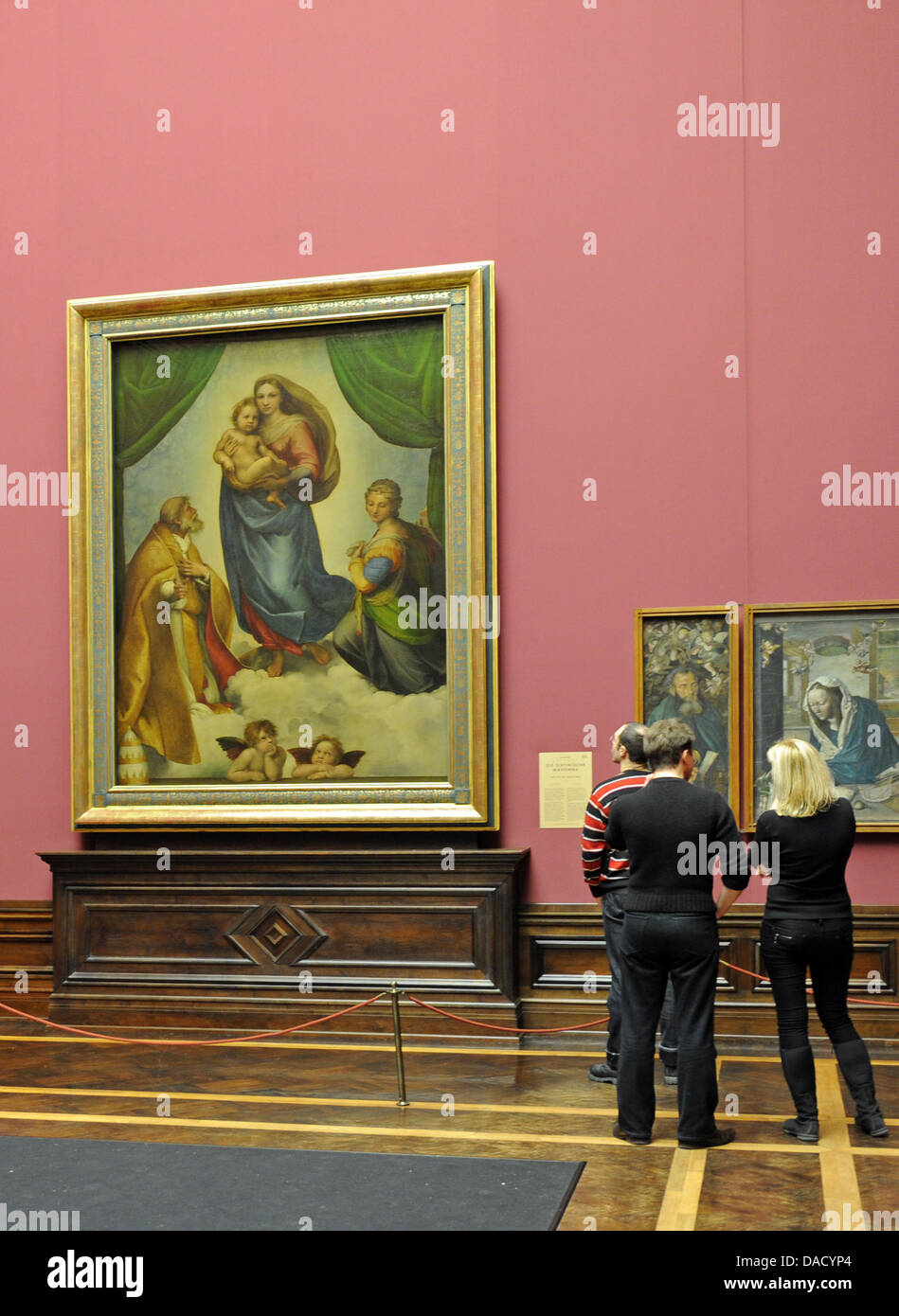Visitors look at the Sistine Madonna by Raphael at the Gemaeldegalerie in Dresden, Germany, 22 December 2011. Dresden's most famous painting will be 500 years old in 2012. Photo: MATTHIAS HIEKEL Stock Photo