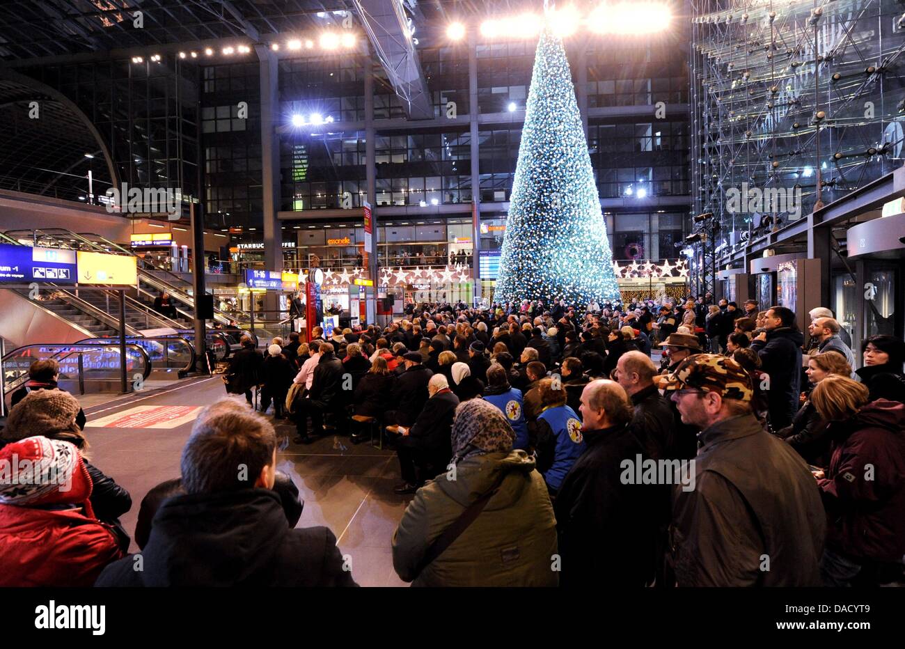 Numerous people attend the Christmas sevice at the main station in Berlin, Germany, 24 December 2011. The Berlin City mission turned the entrance hall of the Berlin main station into a cathedral for a short time while train transportation continued. Photo: Maurizio Gambarini Stock Photo