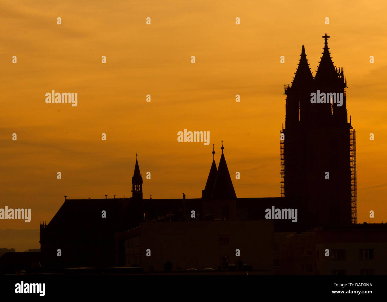 The thick double church towers of the Cathedral of Saints Catherine and Maurice and the towers of the 'Our Lady' Monastery are seen during dusk in Magdeburg, Germany, 28 December 2011. After a sunny day meteorologists predict new rainfalls. Photo: Jens Wolf Stock Photo