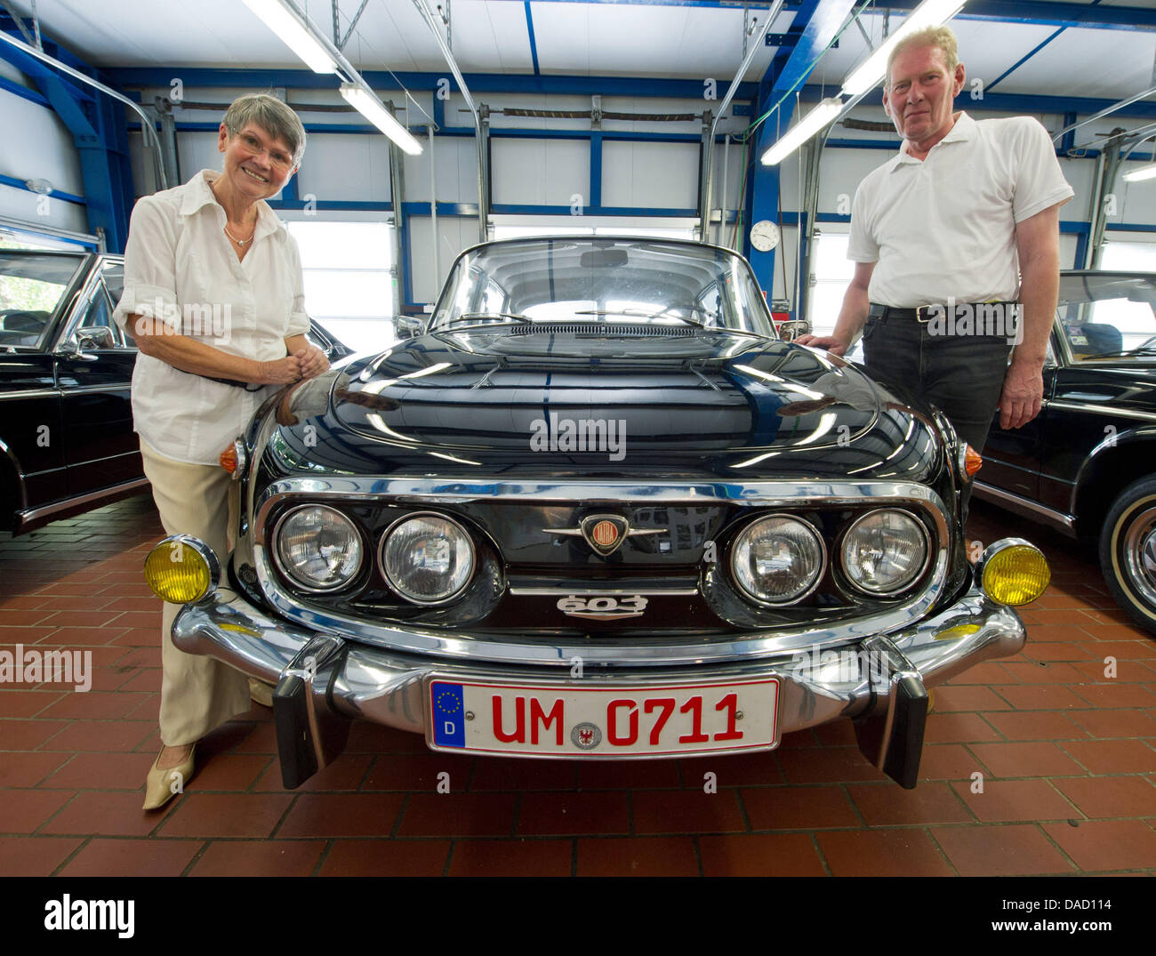 Car owners and collectors Iris and Juergen Riesebeck (R) pose next to a 1975 Tatra 603 in their Tatra car gallery in Angermuende, Germany, 24 August 2011. The Tatra limousine was a favourite car of former Eastern Bloc officials. Nowadays, these cars which were originally manufactured in former Czechoslovakia, have a scarcity value. Photo: Patrick Pleul Stock Photo