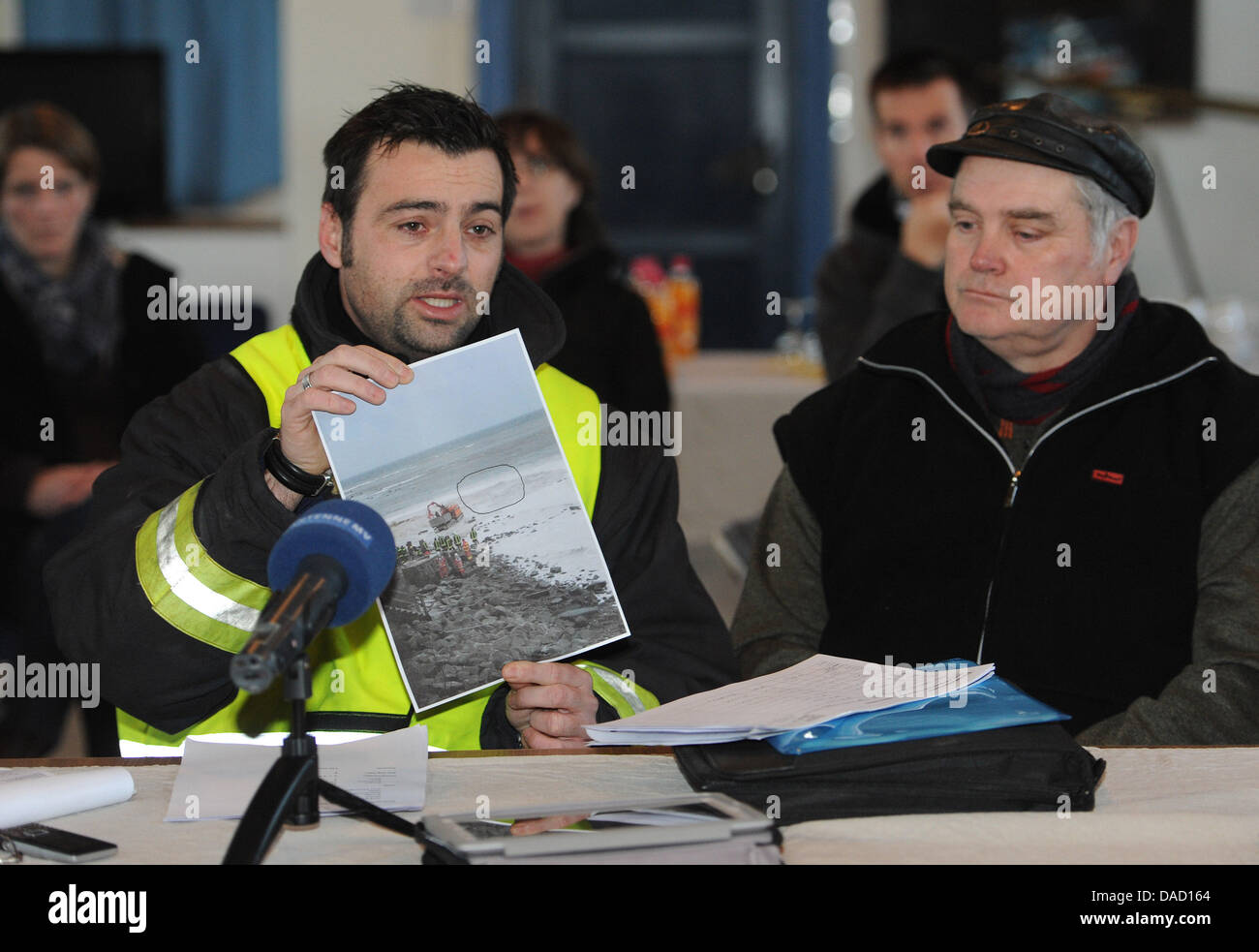 Chief of operations Daniel Hartlieb (L) and mayor of Putgarten, Ernst Heinemann, give a press conference after the search for a girl lost in an accident at the steep coast Kap Arkona at the Baltic Sea was stopped in Putgarten on the island Ruegen, Germany, 30 December 2011. Rescue forces had to stop their search for a ten-year-old girl, who was buried underneath several thousand cu Stock Photo