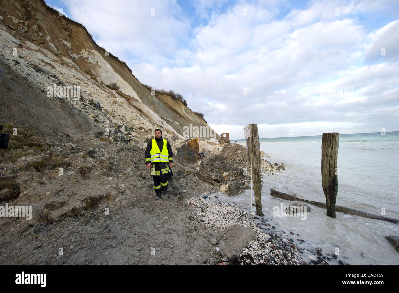 Chief of operations Daniel Hartlieb examines a scene of an accident at the steep coast Kap Arkona at the Baltic Sea in Putgarten on the island Ruegen, Germany, 29 December 2011. Rescue forces had to stop their search for a ten-year-old girl, who was buried underneath several thousand cubic metres of chalk and marl, together with her 14-year-old sister and mother on 26 December 2011 Stock Photo