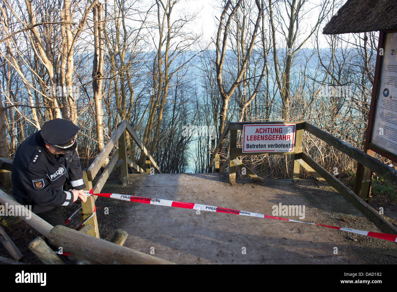 (NEW! - CORRECTED VERSION)   Police closes off a pathway leading towards a scene of an accident at the steep coast Kap Arkona at the Baltic Sea in Putgarten on the island Ruegen, Germany, 30 December 2011. Rescue forces had to stop their search for a ten-year-old girl, who was buried underneath several thousand cubic metres of chalk and marl, together with her 14-year-old sister an Stock Photo