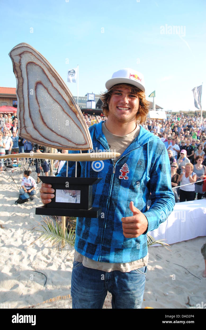 17-year-old German Windsurf World Champion Philip Koester poses with his trophy at Brandenburg beach in Westerland on the island of Sylt, Germany, 02 October 2011. The first German World Champion already claimed the title mid-September in Klitmoeller, Denmark. Photo: Jan Heuer Stock Photo