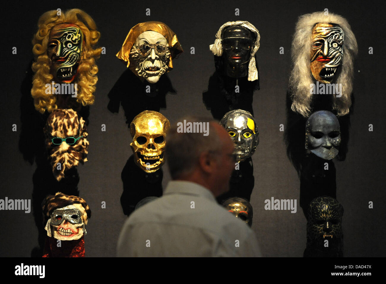 Visitors observe masks of mask-maker Wolfgang Utzt at Museum of Arts and Crafts in Hamburg, Germany, 05 October 2011. The exhibition 'Time Passes Masks. Wolfgang Utzt - Works' opens