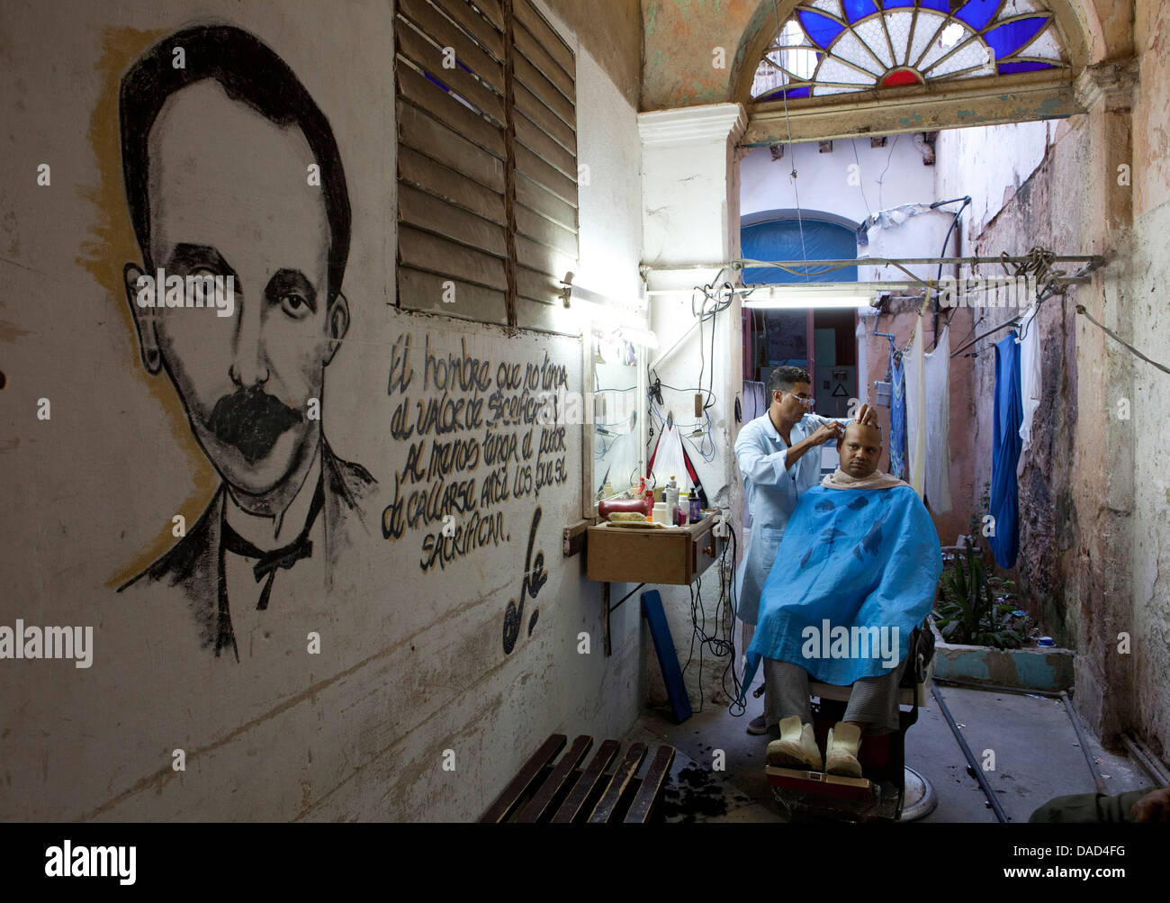 Man having haircut in backstreet barber shop, Havana Viejo, Havana, Cuba, West Indies, Central America Stock Photo