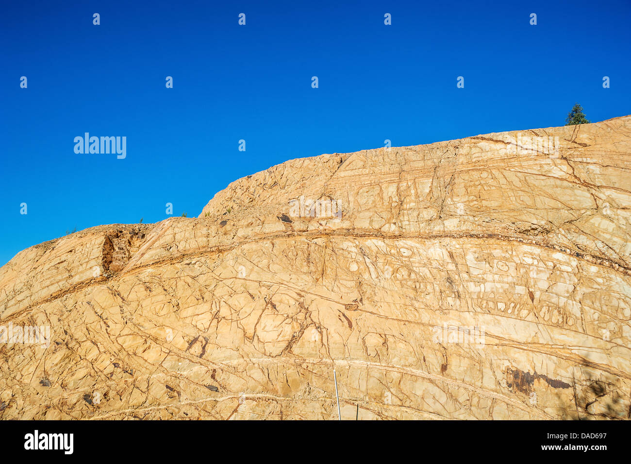 A rock face scarred by excavation Stock Photo