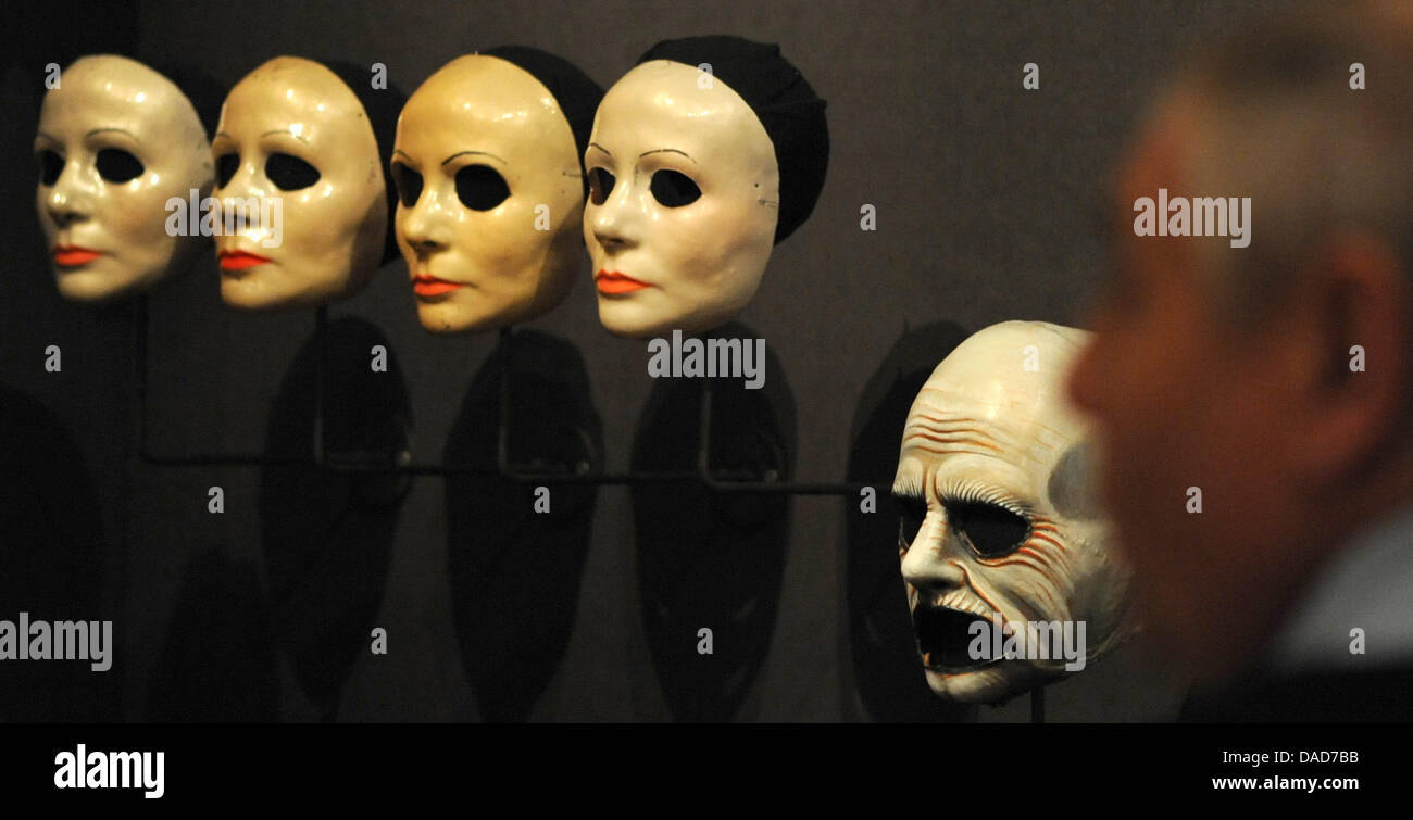 A visitor stands in front of masks of the mask-maker and make-up artist  Wolfgang Utzt at the Museum of Arts and Crafts in Hamburg, Germany, 05  October 2011. The exhibition 'Time Passes