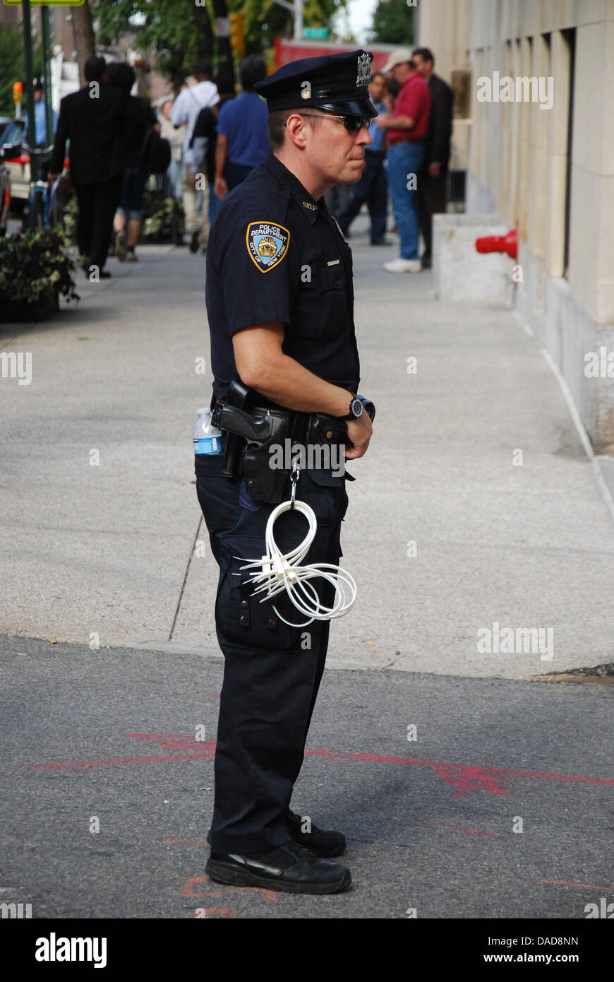 A police officer stands in front of the house of bank manager Jamie ...