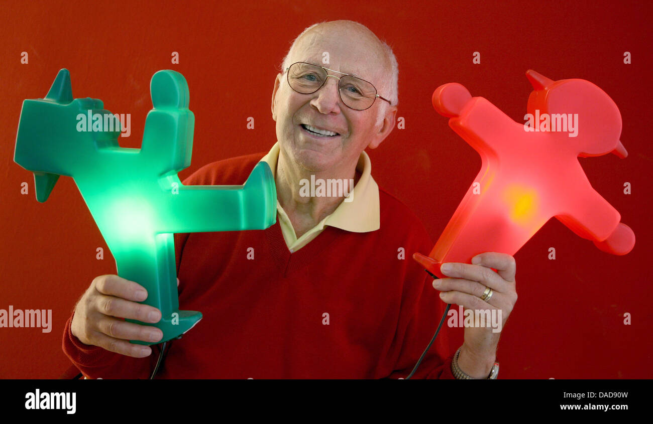 (FILE) An archive photo dated 10 May 2007  shows Karl Peglau, designer of the two East German Ampelmaennchen (little traffic light man), holding a green and red Ampelmaenchen in his hands in Berlin, Germany, 15 August 2011. After 50 years of letting telling people to stop, the man in the signal doesn't look old - on the contrary: the helper of pedestrians with a pug nose and hat is Stock Photo