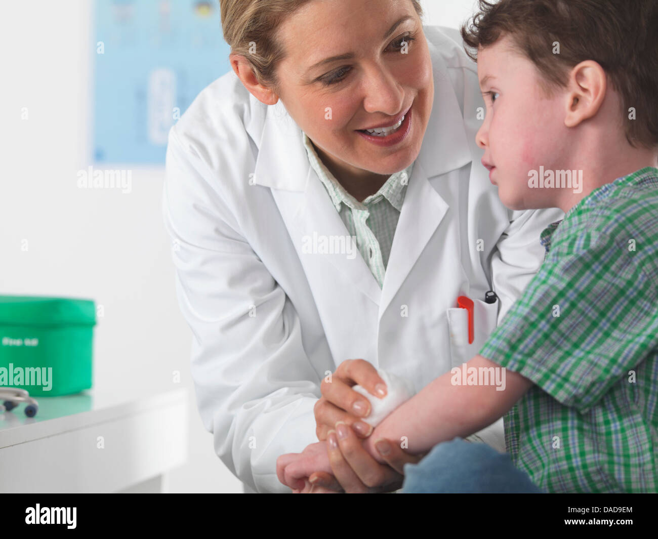 Doctor caring for small boy with injury Stock Photo