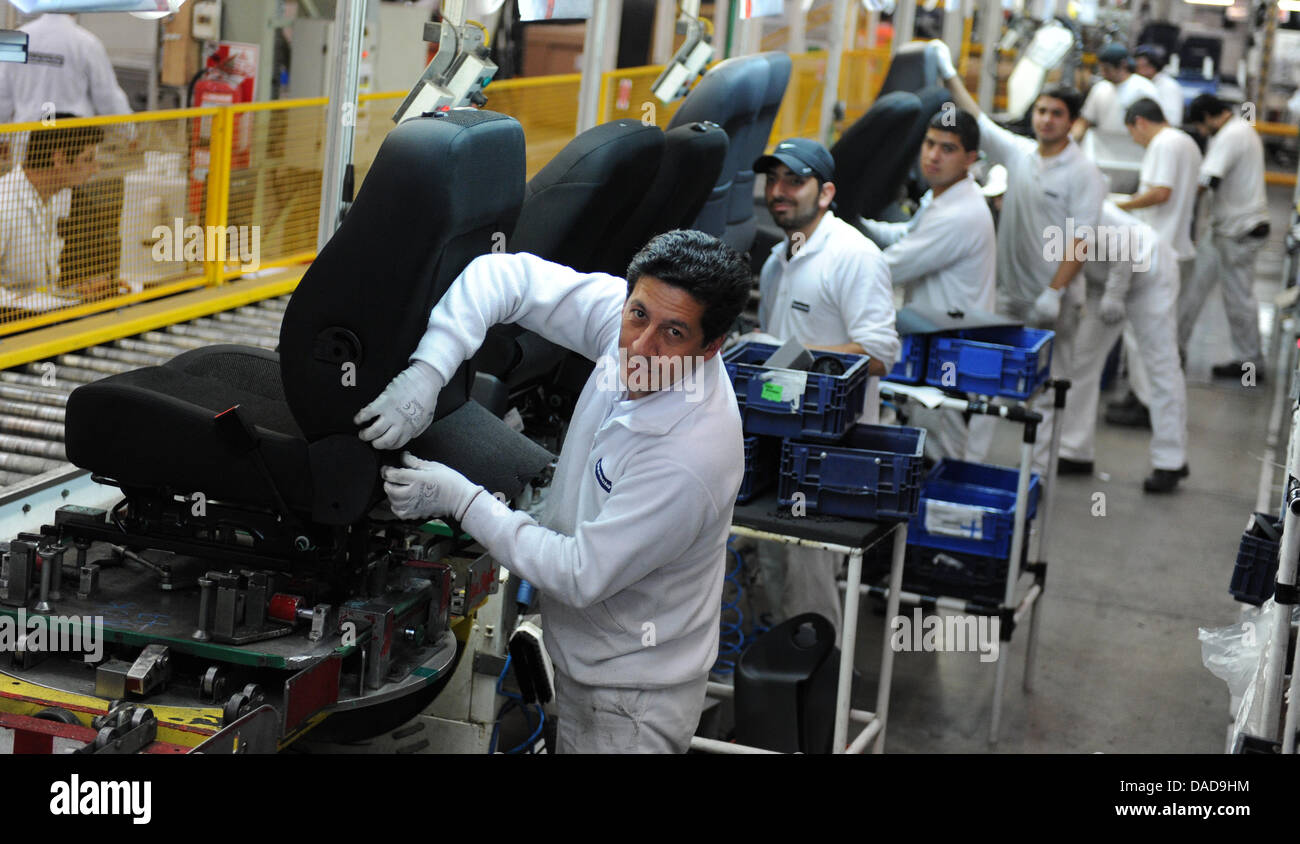 Employees assemble seats at the factory of car parts supplier Faurecia