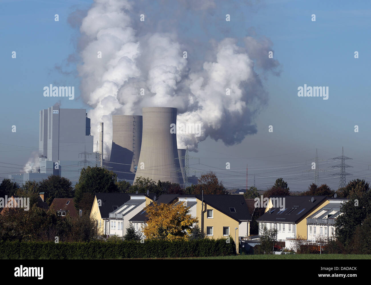 Smoke and water vapor rise from the cooling towers and chimneys of the Neurath II brown coal power station owned by RWE near Grevenbroich, Germany, 14 October 2011. Power plants that use fossil fuels emit large amounts of the greenhouse carbon dioxide (CO2), which is the leading cause of global warming. Photo: Oliver Berg Stock Photo