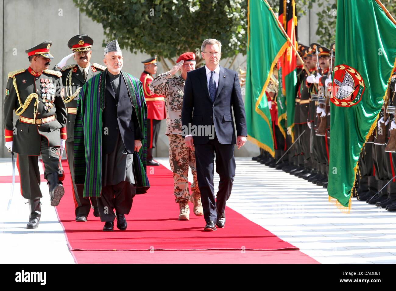 German President Christian Wulff (C) is welcomed by the Afghan President Hamid Karsai in Kabul, Afghanistan, 16 October 2011. The German head of state is cureently in Afghanistan for a state visit. Photo: WOLFGANG KUMM Stock Photo