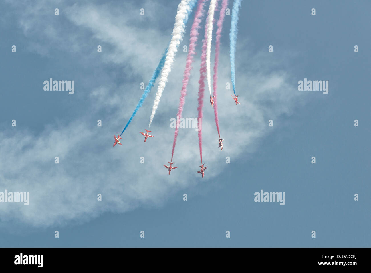 British Royal Air Force Red Arrows Military Aerobatic Display Team dive out of the sky in their Hawk Jet Trainers Stock Photo