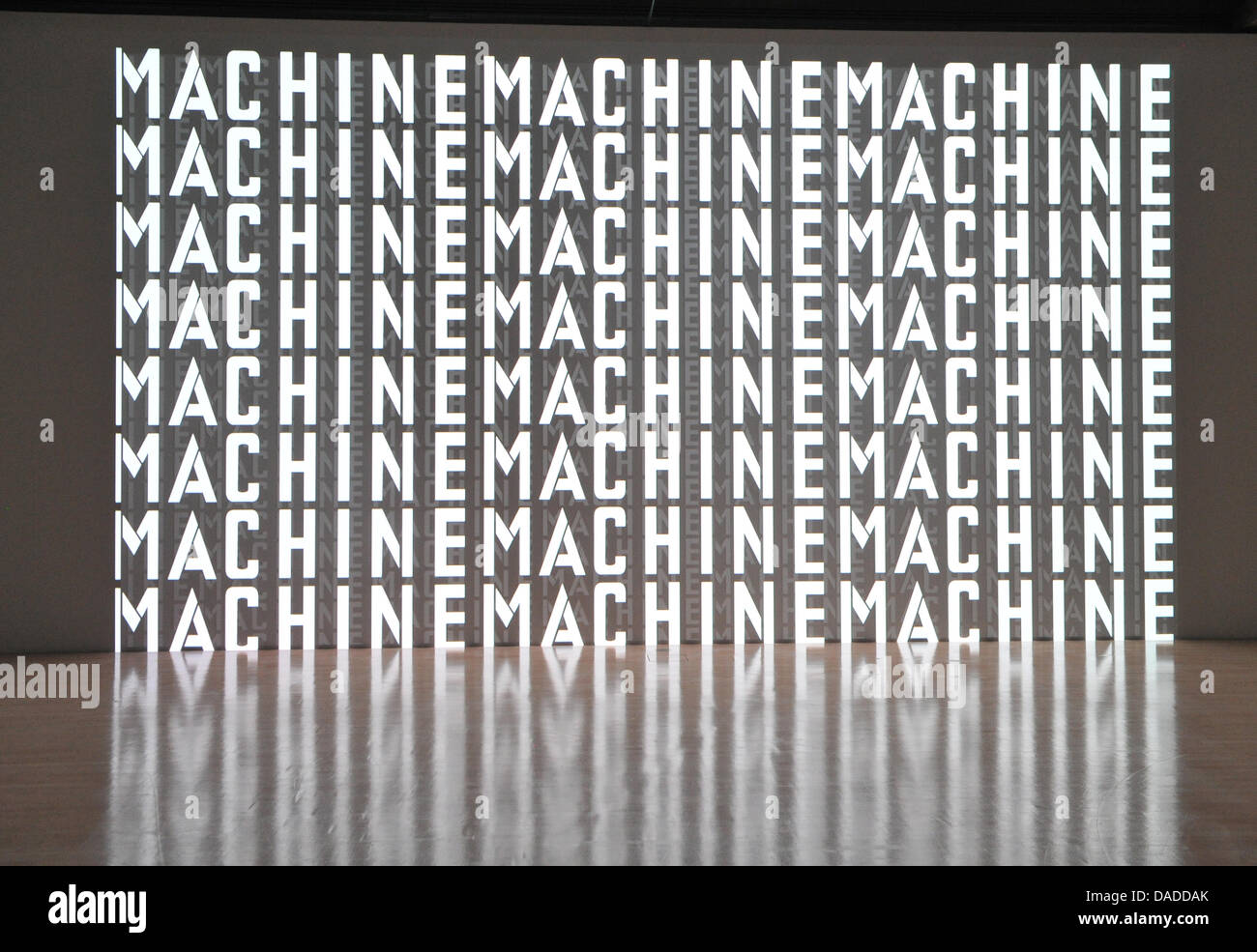 A 3D video installation with the writing 'Machine' is seen during the video press preview of the exhibition 'Kraftwek 3-D Video Installation' at the Kunstbau of the Municipal Gallery in Lenbachhaus in Munich, Germany, 13 October 2011. The design of the exhibition is meant to make the minimalistic sounds and images of Kraftwerk tangible to a broad public. The video installation can  Stock Photo