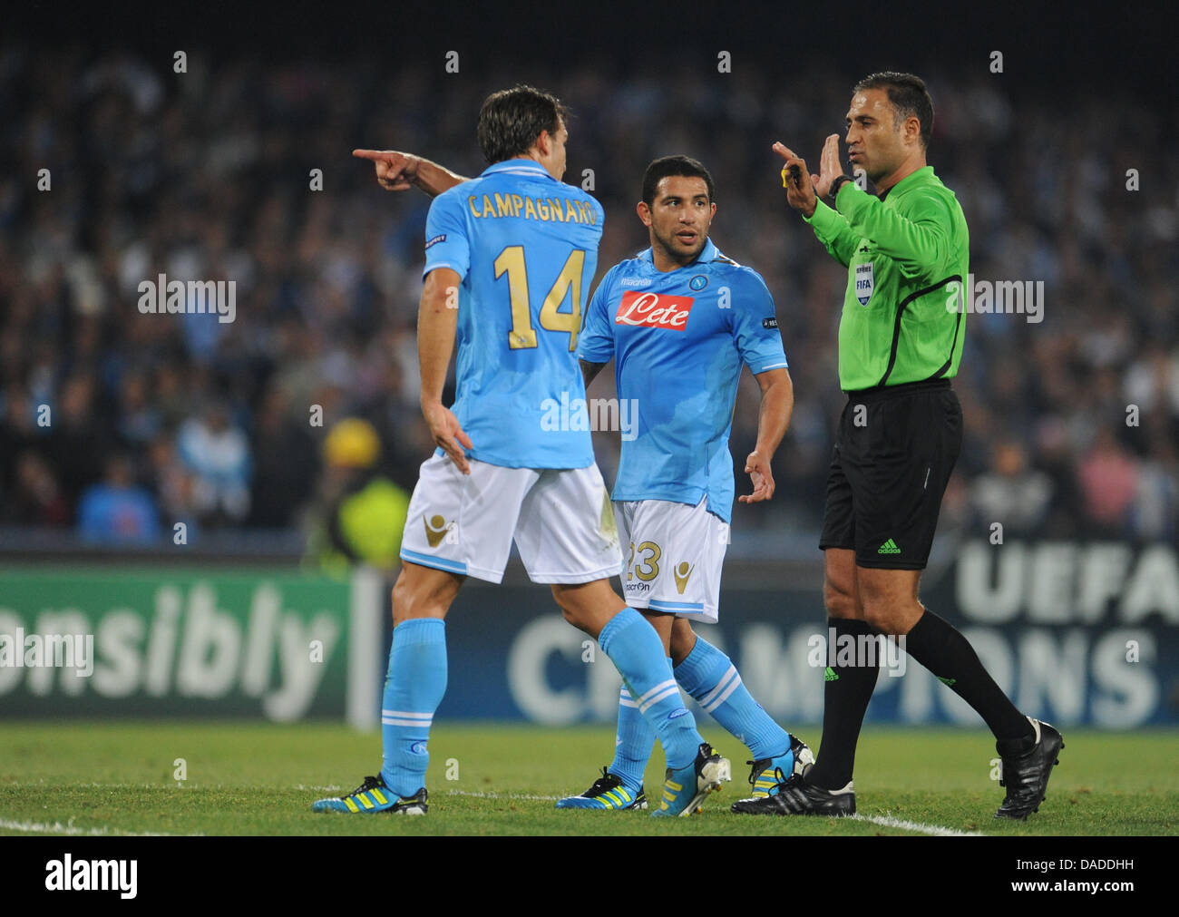 Christian Hugo Campagnaro (L) and Walter Gargano of Naples discuss with referee Olegario Benquerenca (R) during the Champions League group A soccer match between FC Bayern Munich and SSC Napoli at Stadio San Paolo in Naples, Italy, 18 October, 2011. The match ended 1-1. Photo: Andreas Gebert Stock Photo