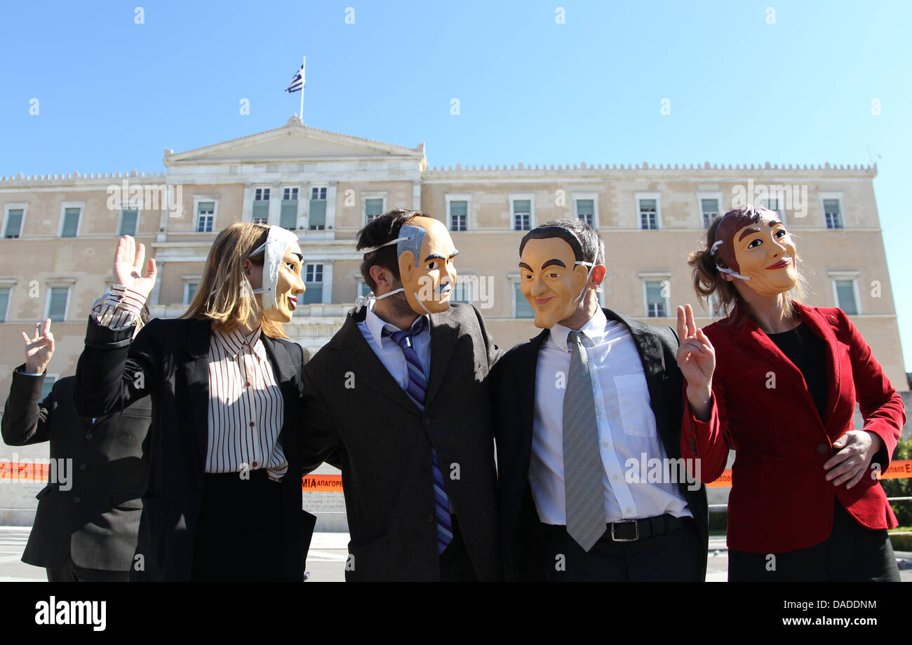 Protesters wear masks of politicians in front of a government building
