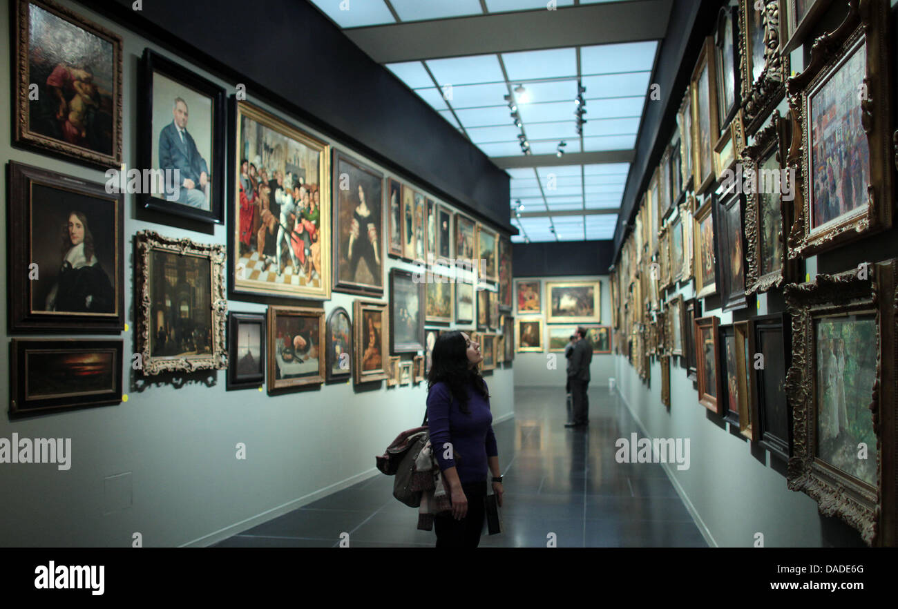 A woman looks at paintings in Cologne, Germany, 20 October 2011. The special exhibition 'Panopticon - The Secret Treasures of the Wallraf' runs from 21 October 2011 until 22 January 2012 at the Wallraf Richartz Museum in Cologne. Photo: OLIVER BERG Stock Photo