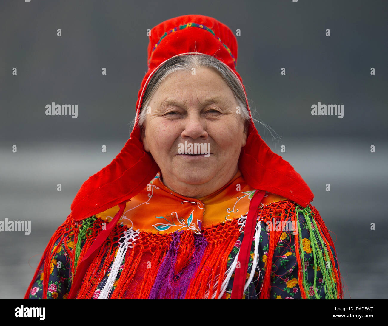 An elderly lady of the indigenous Sami people wears a traditional dress ...
