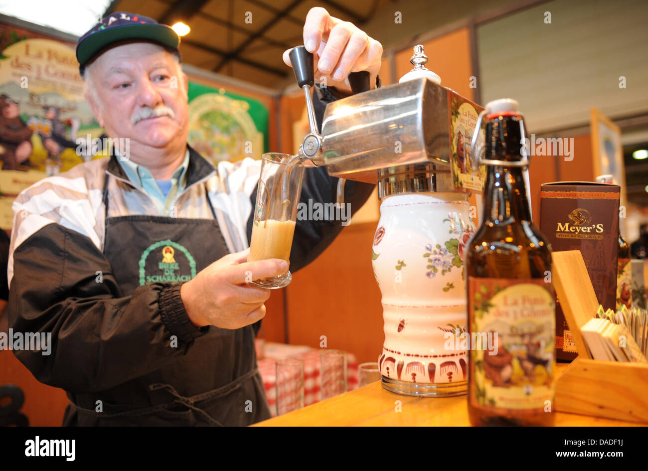 Beer brewer Joseph Donninger of the Lauth brewery pulls a pint of fresh  beer during the international beer fair in Strasbourg, France, 21 October  2011. The beer was stored in old whiskey