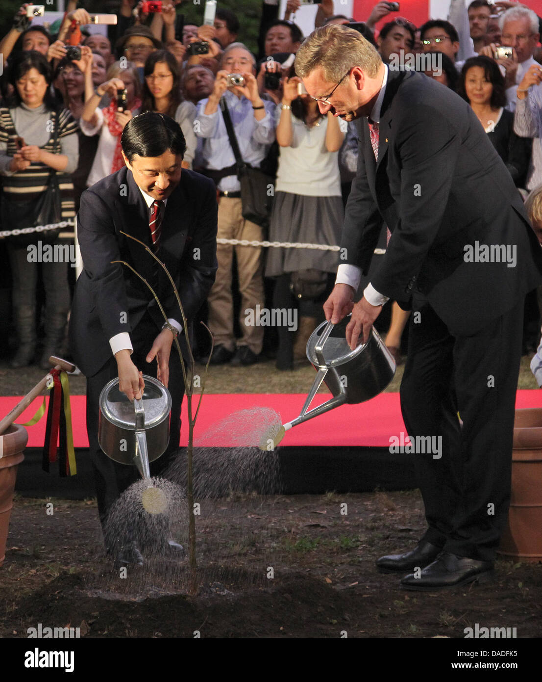 German President Christian Wulff (R) and Japanese Crown Prince Naruhito plant a basswood tree at the German festival in Tokyo, Japan, 23 October 2011. The German head of state will be in Japan for six days. Photo: WOLFGANG KUMM Stock Photo