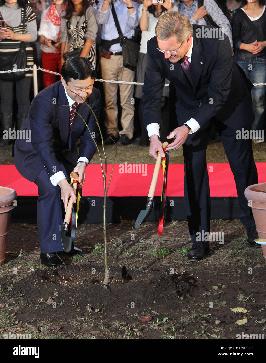 German President Christian Wulff (R) and Japanese Crown Prince Naruhito plant a basswood tree at the German festival in Tokyo, Japan, 23 October 2011. The German head of state will be in Japan for six days. Photo: WOLFGANG KUMM Stock Photo