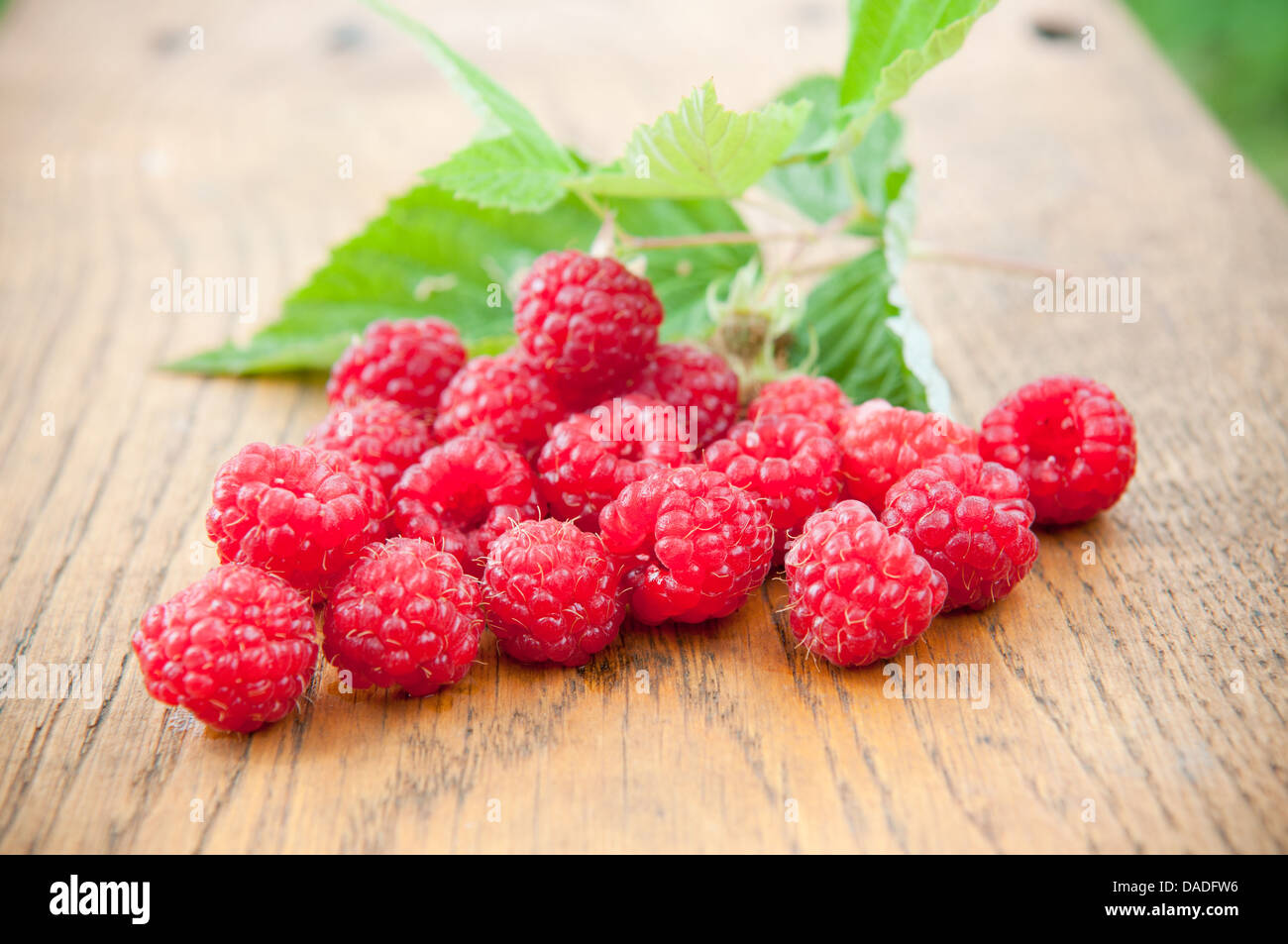 Delicious raspberries on wooden background Stock Photo
