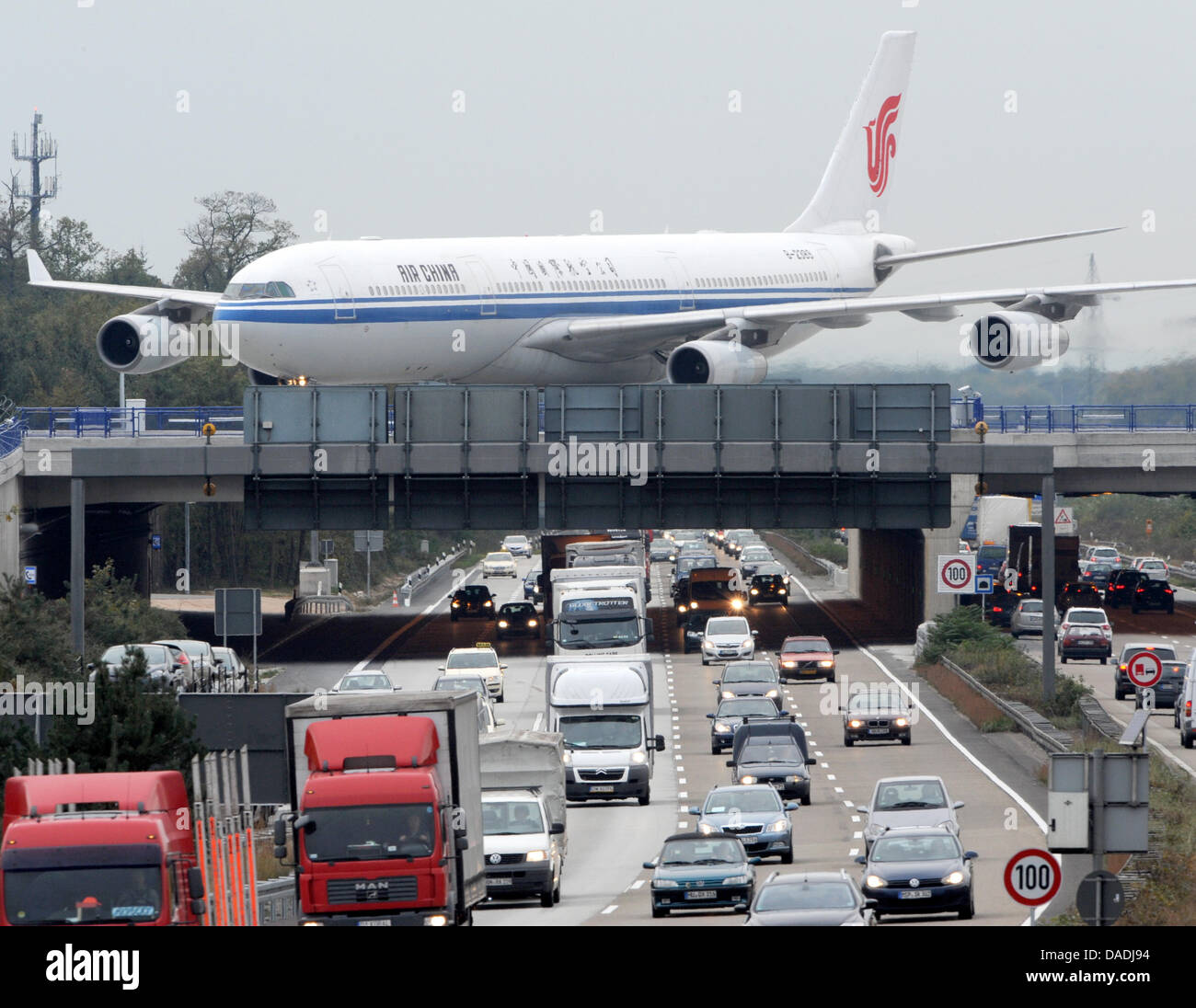 An airbus 340-300X of Air China drives down a new runway situated above the motorway A3 towards the airport in Frankfurt Main, Germany, 25 October 2011. The new fourth runway highers the capacity of the airport by 50 percent. Photo: Arne Dedert Stock Photo