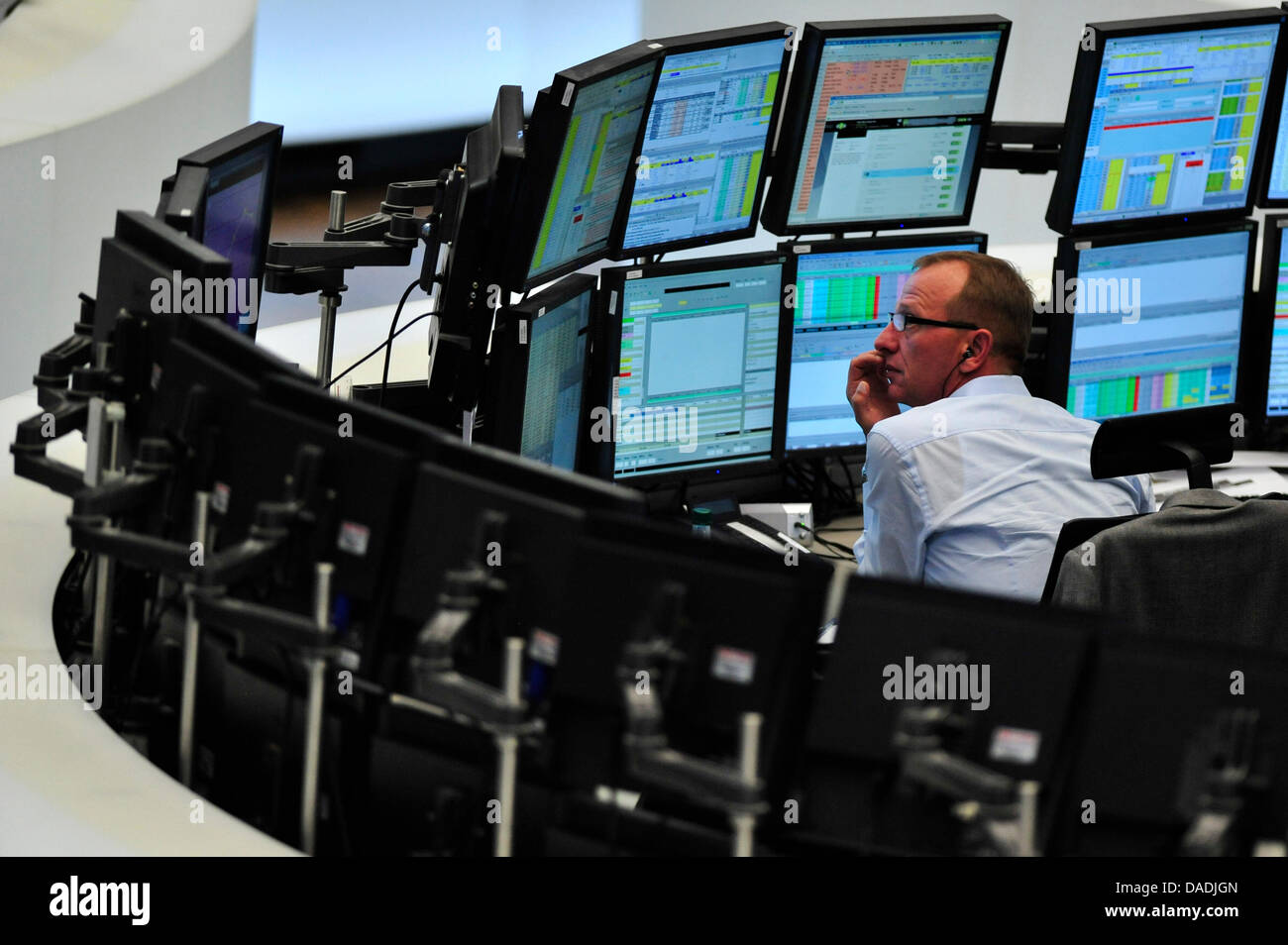 A stock market trader sits at his desk at the German stock exchange in Frankfurt Main, Germany, 27 October 2011. The DAX is at its highest point since the beginning of August with substantial gains after the EU summit on the euro debt crisis. Photo: MARC TIRL Stock Photo