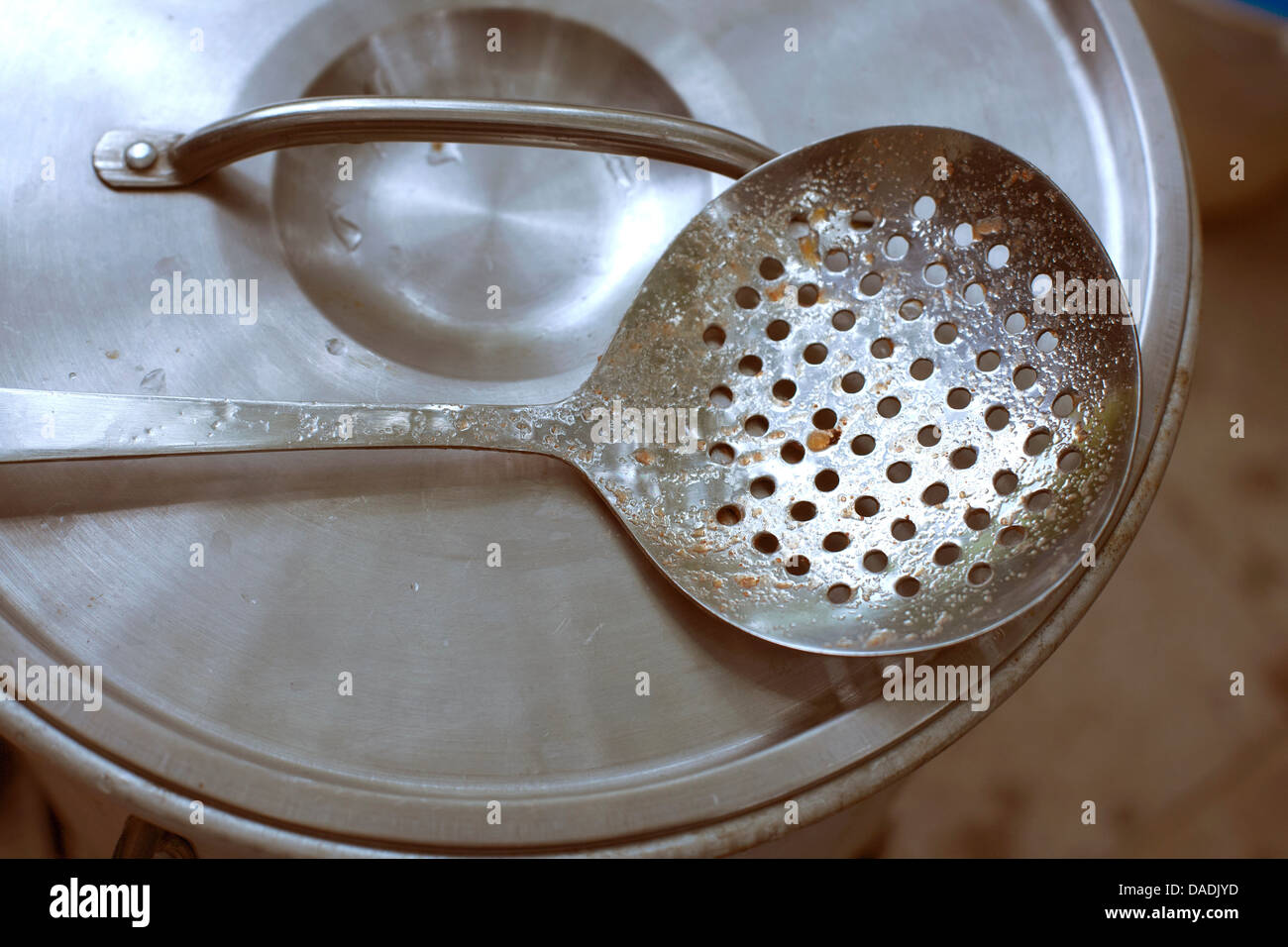 Close up of stainless steel ladle on lid of pot Stock Photo