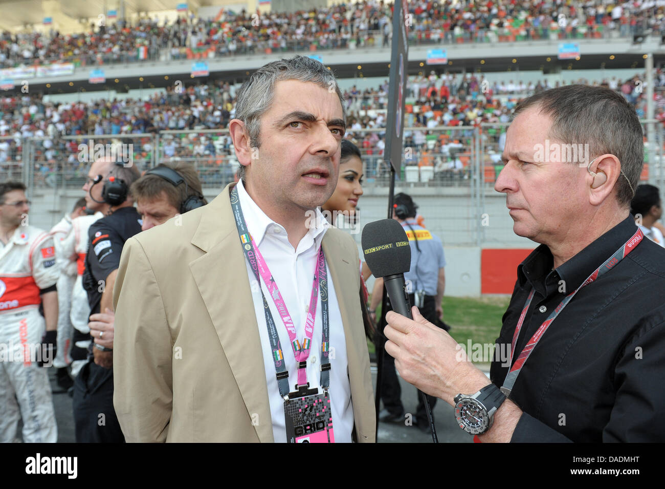 British comedian Rowan Atkinson ets interviewed by former British Formula One driver Martin Brundle in the grid just before the start of the race at the Buddh International Circuit, Greater Noida, India, 30 October 2011. The first-ever Formula One Grand Prix of India will take place on 30 October 2011. Photo: David Ebener dpa Stock Photo