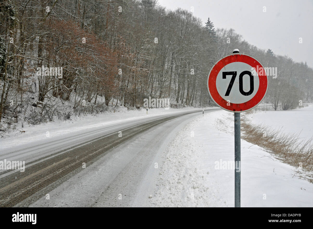 snow-slicked road in shower of sleet, Germany, Baden-Wuerttemberg, Swabian Alb, Kleines Lautertal Stock Photo