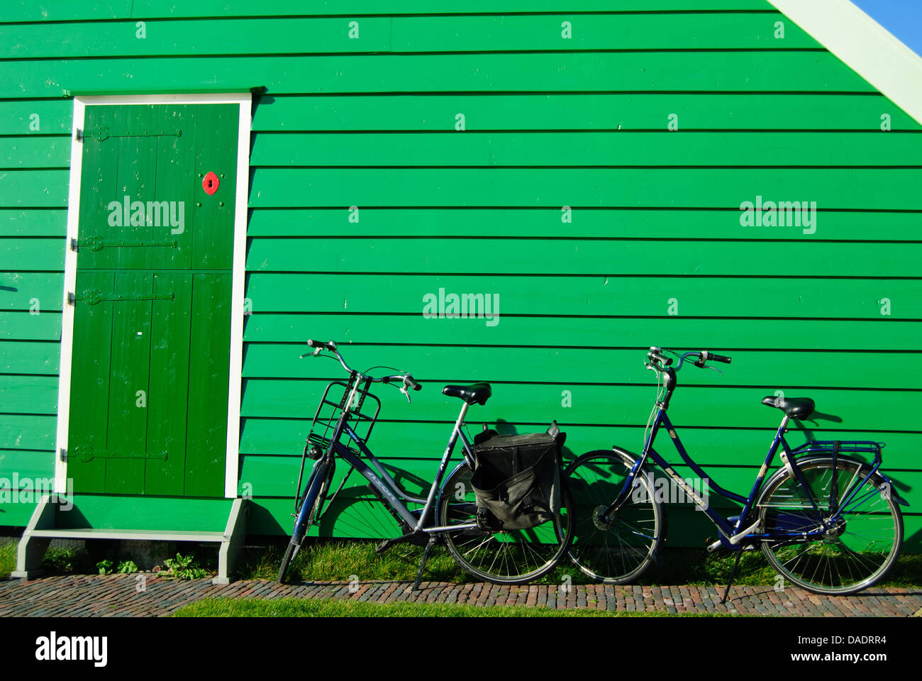 Green wooden wall and bicycles Stock Photo Alamy