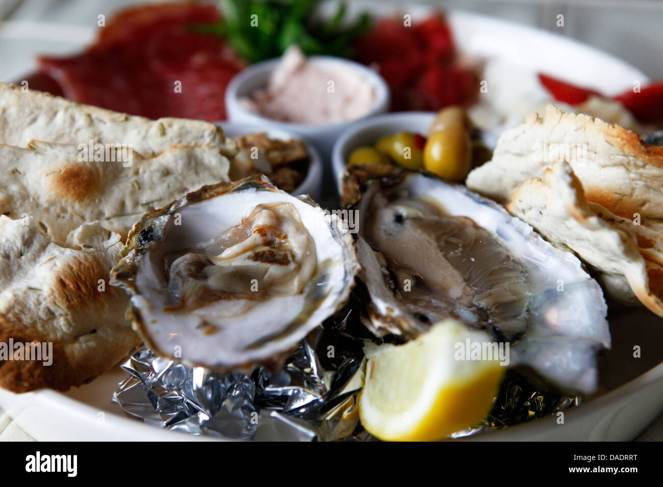 A platter of regional oyster, seafood and meat is served in Antwerp, Belgium. Stock Photo