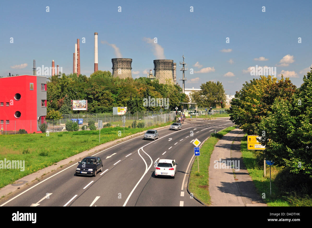 road traffic in front of the vent stacks and burners of an oil refinery, Germany, North Rhine-Westphalia, Godorf bei Wesseling Stock Photo