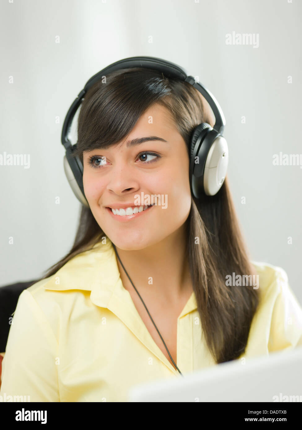 Young woman wearing headphones and smiling Stock Photo