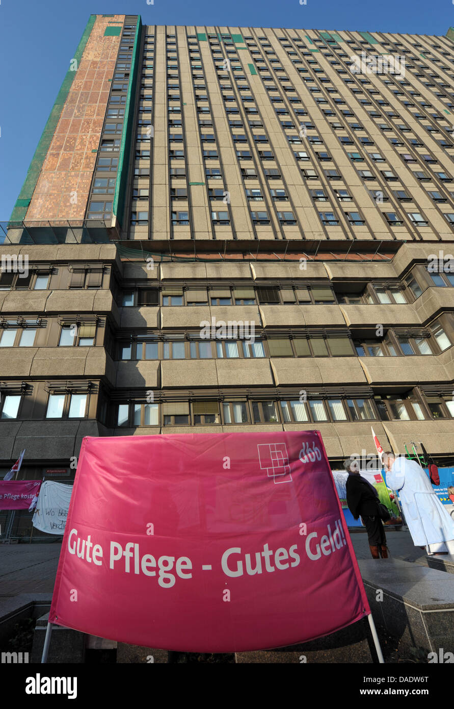 A banner lettered 'Gute Pflege kostet' ('Good care costs money') is seen in front of the Charite in Berlin, Germany, 02 November 2011. Around 200 staff members of the subsidiary Facility Management call for a wage agreement for eight weeks now.   Photo: SOEREN STACHE Stock Photo