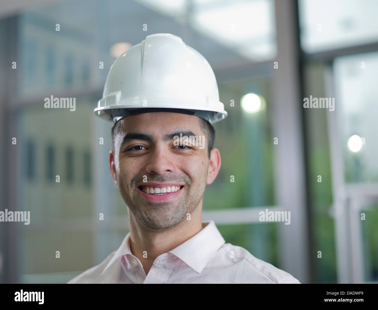 Mid adult builder wearing hard hat, portrait Stock Photo Alamy