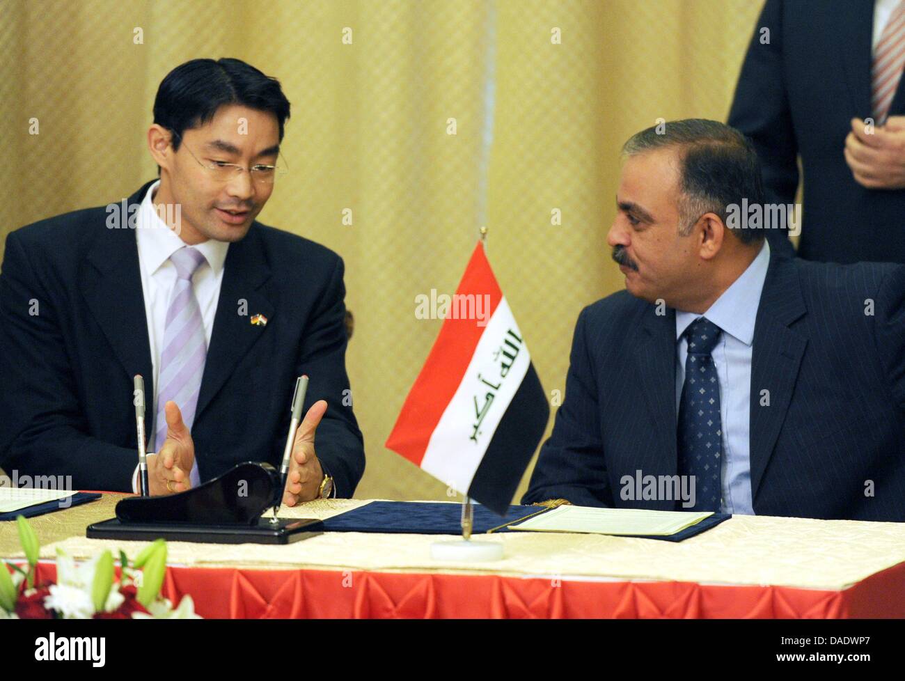 German Minister of Economics and Technology Philipp Roesler (L) and Iraqi Minister of Industry and Minerals Ahmed Al Karbuli sign a protocol to broaden economic cooperation between the two countries in Baghdad, Iraq, 03 November 2011. The goal of Roesler's two-day trip to the war torn country is the further expansion of economic relations. Photo: RAINER JENSEN Stock Photo