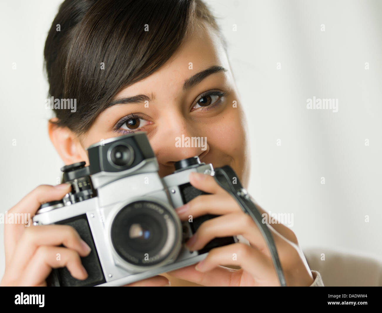 Young woman holding camera, portrait Stock Photo - Alamy