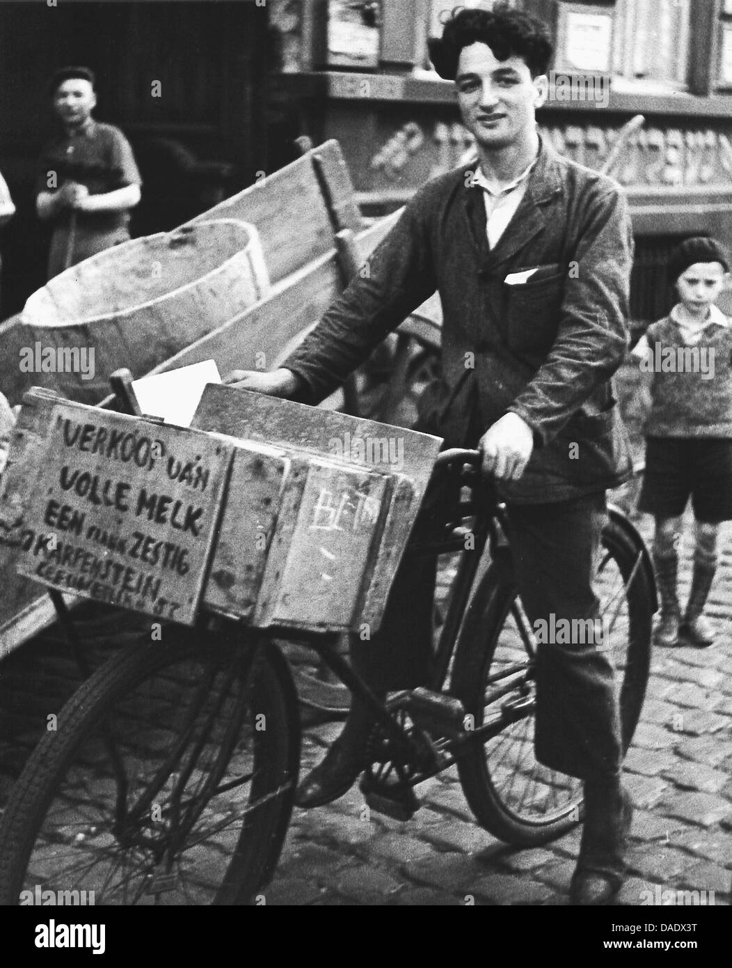 Antwerp 1934, delivery boy on bike selling milk in jewish quarter. Image by photographer Fred Stein (1909-1967) who emigrated 1933 from Nazi Germany to France and finally to the USA. Stock Photo