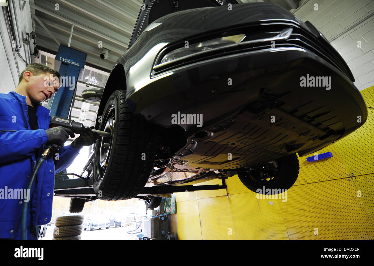 A mechanic mounts snow tires to a vehicle in Hamburg, Germany, 03