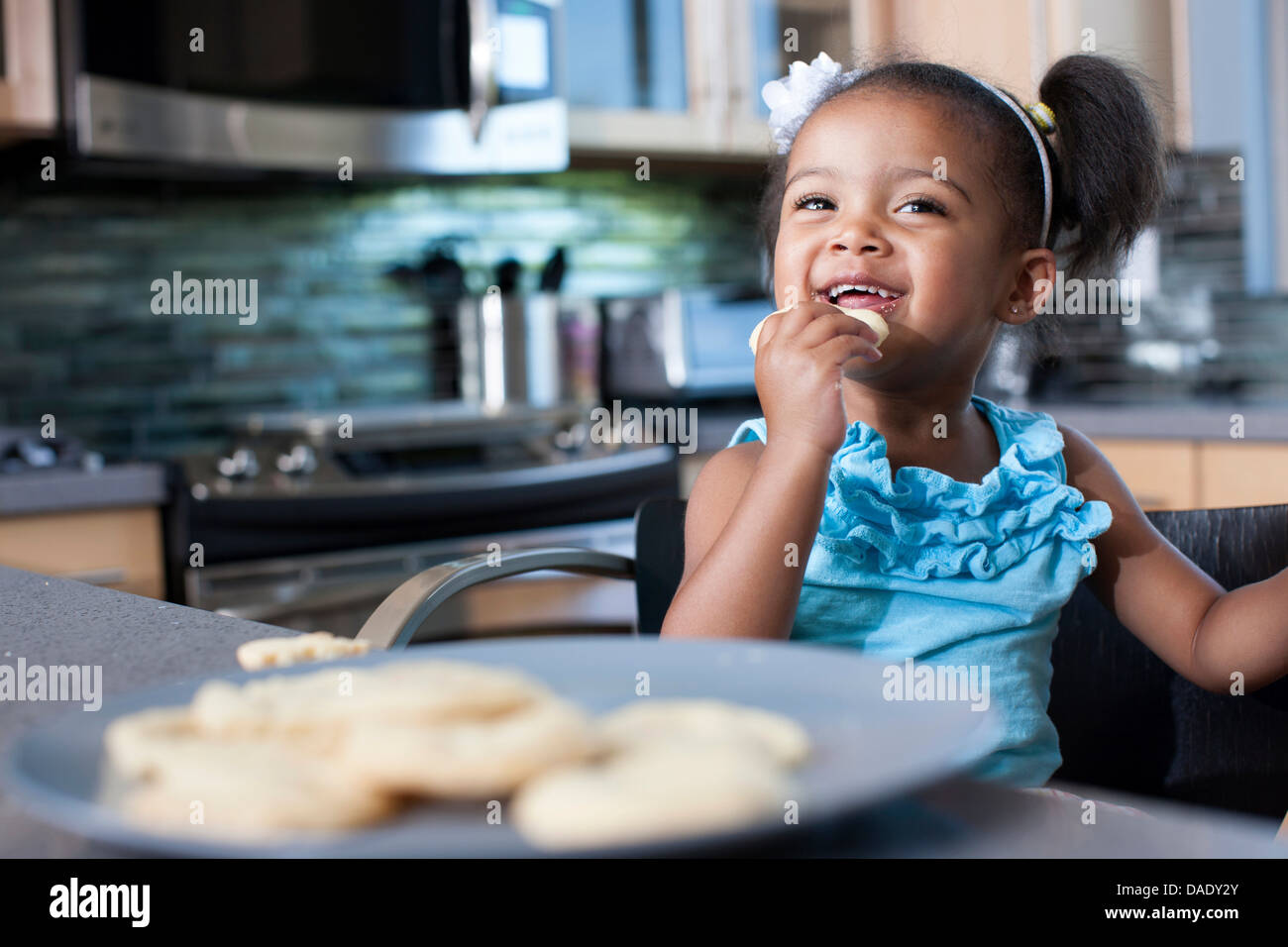 Young girl eating biscuits Stock Photo Alamy