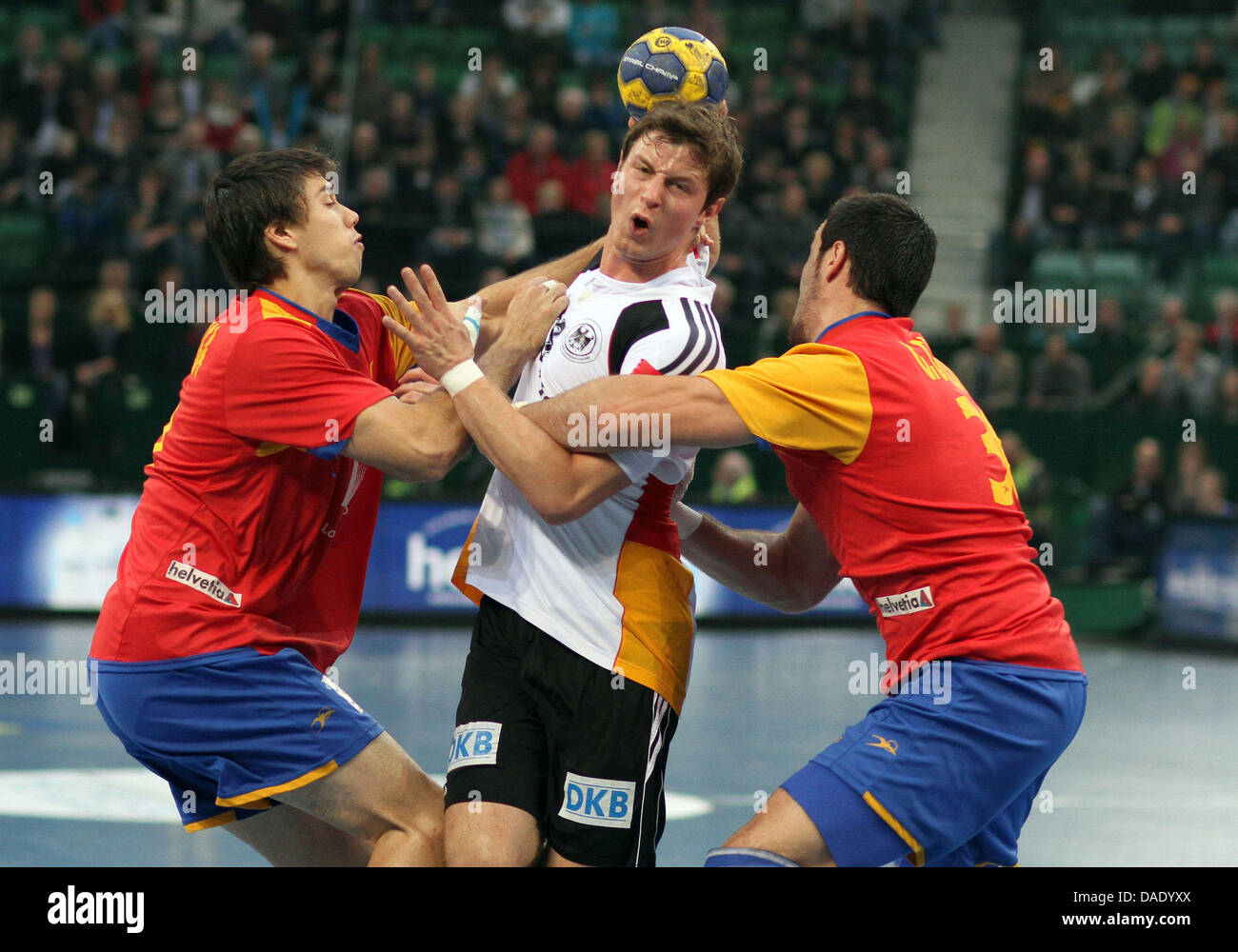 Germany's Martin Strobel (M) and Spain's Christian Ugalde and Gedeon Guardiola (R) vie for the ball during Handball Supercup match Germany vs Spain at Gerry Weber Stadium in Halle, Germany, 06 November 2011. Photo: Oliver Krato Stock Photo