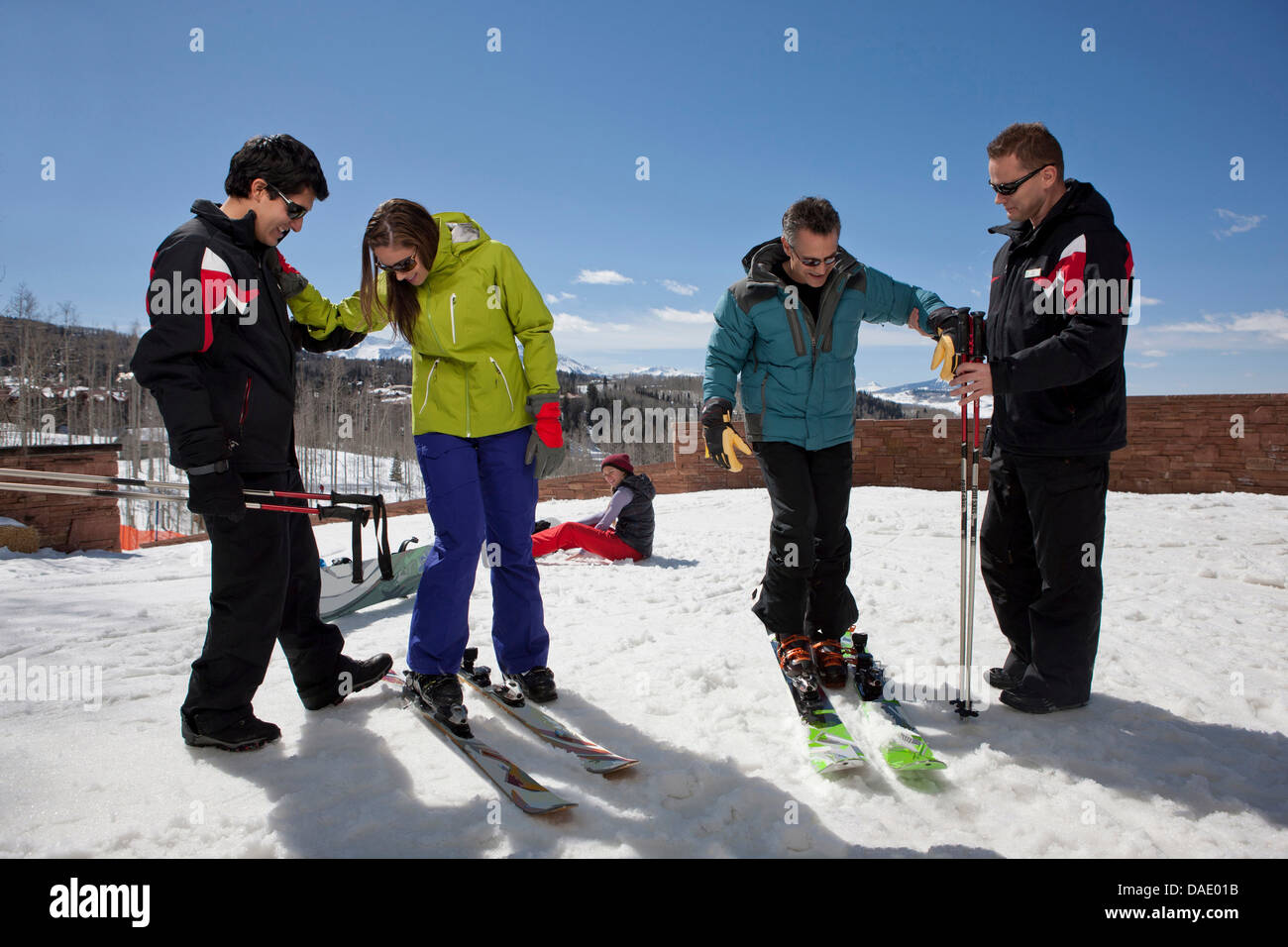 Mature man and young woman with ski instructors on ski slope Stock Photo