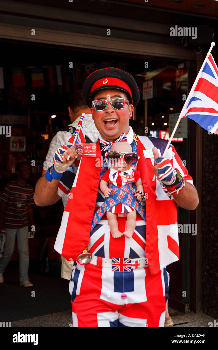 London, UK, A member of staff in Union Jack clothing complete with a Royal baby doll outside the Cool Brittania Souvenir store in Piccadilly Circus. Credit:  Keith Larby/Alamy Live News Stock Photo
